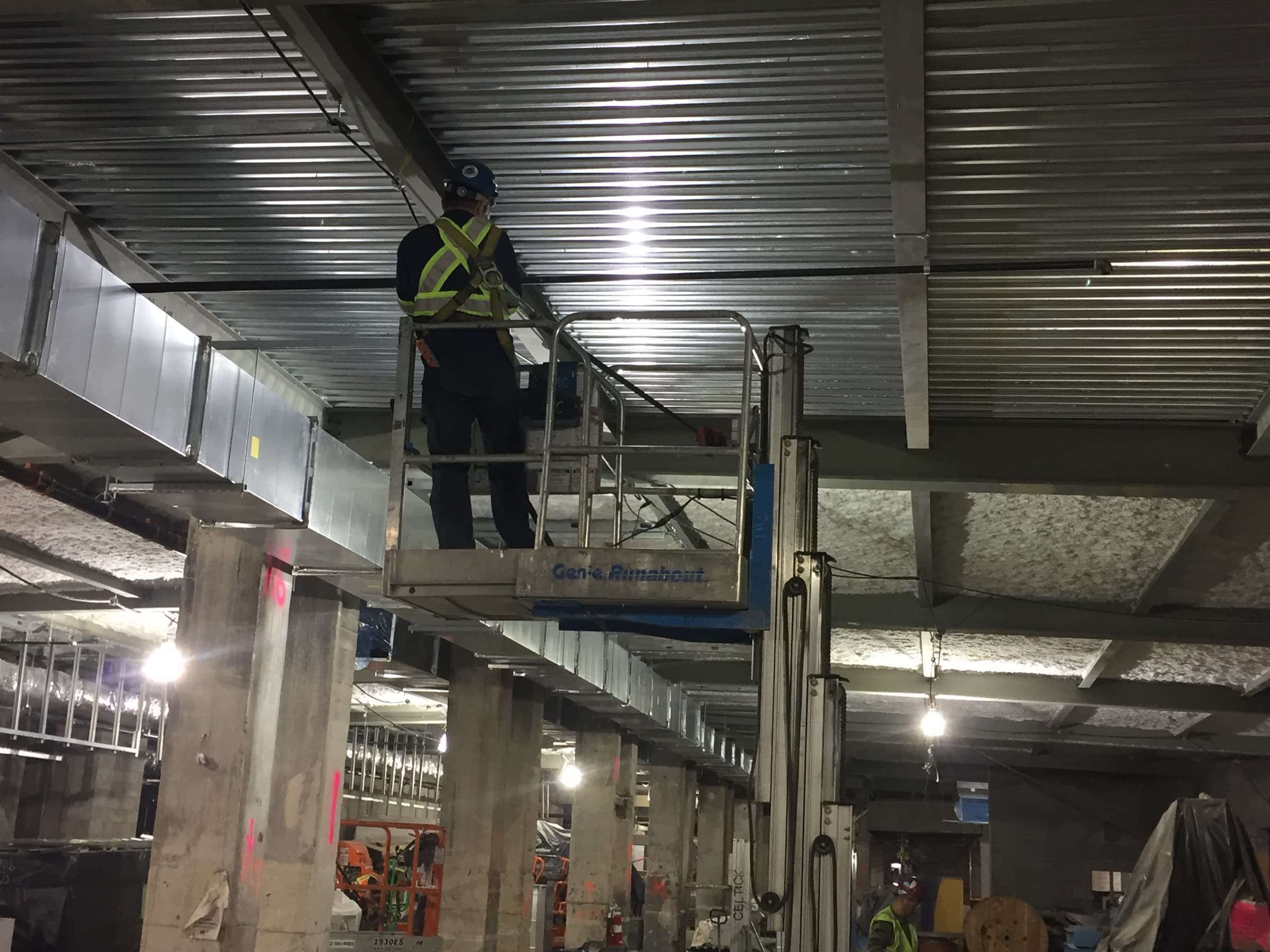 Fire-protection technician installing overhead piping